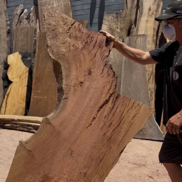 Scott Mills presents a large figured eucalyptus slab in the Ironwood Mills slab yard in Phoenix