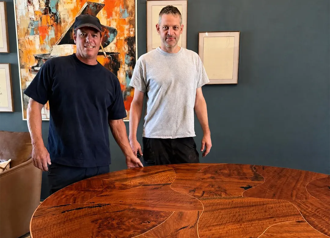 Scott and Phil of Ironwood Mills stand behind the finished copper inlay dining table in the clients’ home Scott and Phil of Ironwood Mills stand behind the finished copper inlay dining table in the clients’ home